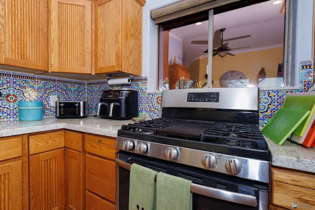 13220 E 55th St, Yuma, AZ 85367 - kitchen featuring a ceiling fan, a toaster, stainless steel gas range oven, and tasteful backsplash