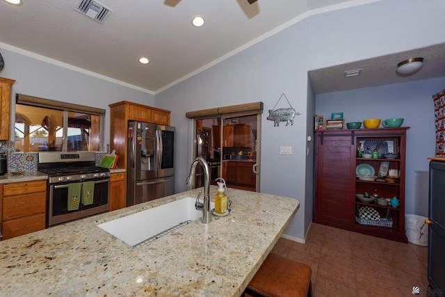 13220 E 55th St, Yuma, AZ 85367 - kitchen featuring brown cabinetry, visible vents, lofted ceiling, ceiling fan, and stainless steel appliances
