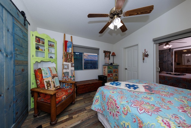 13220 E 55th St, Yuma, AZ 85367 - bedroom featuring a barn door, ceiling fan, lofted ceiling, and hardwood / wood-style flooring