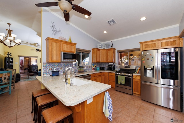 13220 E 55th St, Yuma, AZ 85367 - kitchen featuring a peninsula, lofted ceiling, a sink, ceiling fan with notable chandelier, and stainless steel appliances