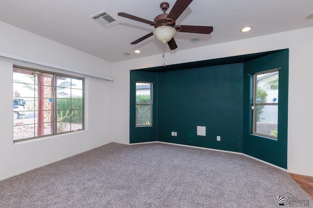 carpeted empty room with recessed lighting, ceiling fan, visible vents, and baseboards