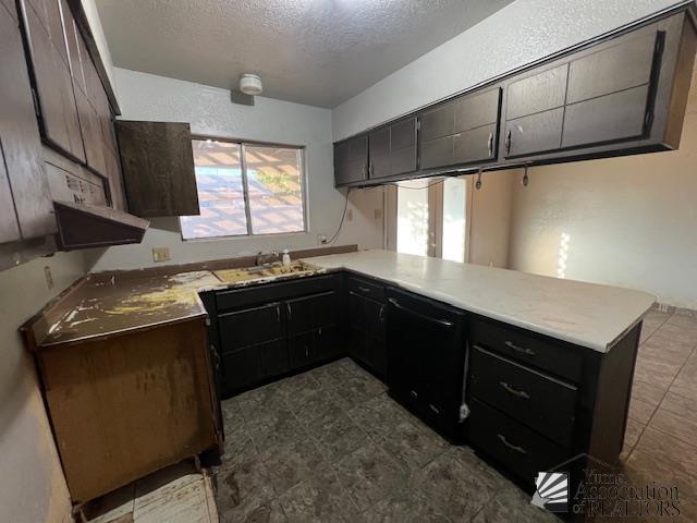 2232 W 19th St, Yuma, AZ 85364 - kitchen with a textured ceiling, a peninsula, dishwasher, and light countertops