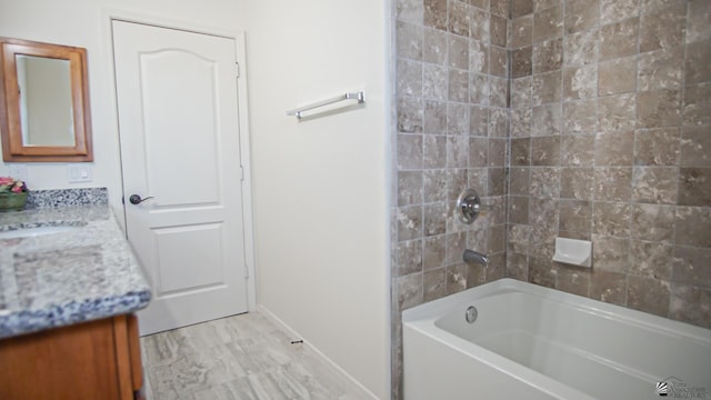 full bathroom with baseboards, bathing tub / shower combination, and vanity