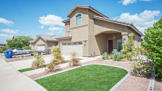 mediterranean / spanish-style home featuring concrete driveway, a tiled roof, an attached garage, and stucco siding