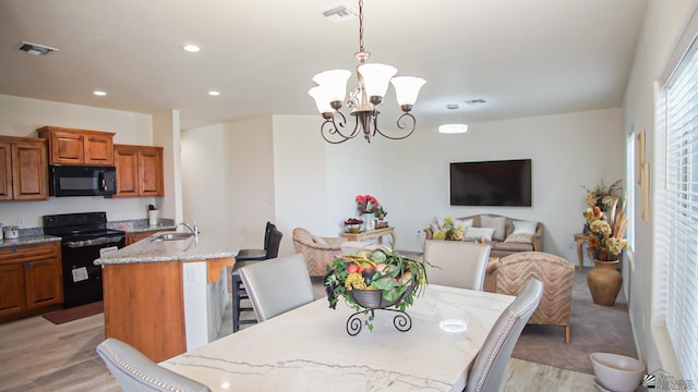 dining area with recessed lighting, visible vents, light wood-style flooring, and an inviting chandelier