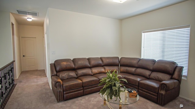 carpeted living room featuring a wealth of natural light and visible vents