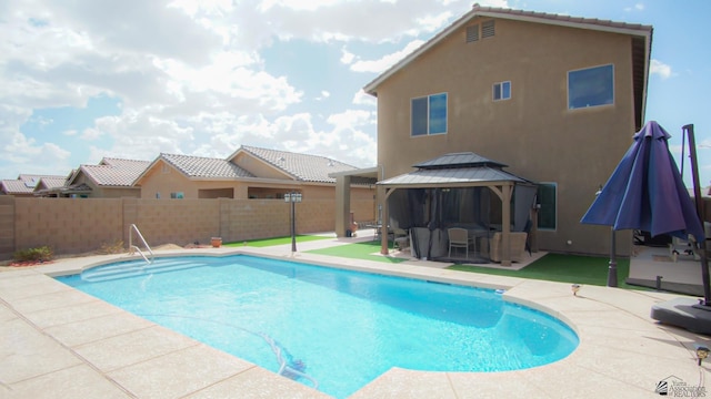 view of swimming pool featuring a gazebo, a patio area, a fenced in pool, and fence