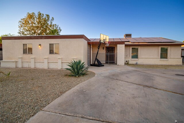 1836 W Allen St, Yuma, AZ 85364 - view of front of house featuring roof mounted solar panels, brick siding, and stucco siding