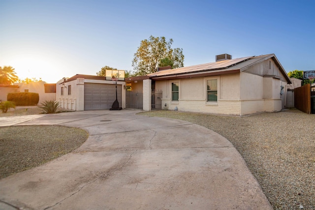 1836 W Allen St, Yuma, AZ 85364 - view of front of property featuring solar panels, concrete driveway, a garage, brick siding, and stucco siding