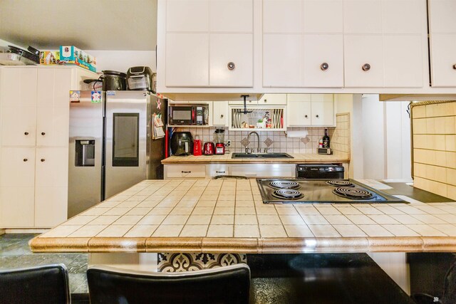 1836 W Allen St, Yuma, AZ 85364 - kitchen featuring black appliances, tile counters, tasteful backsplash, and open shelves