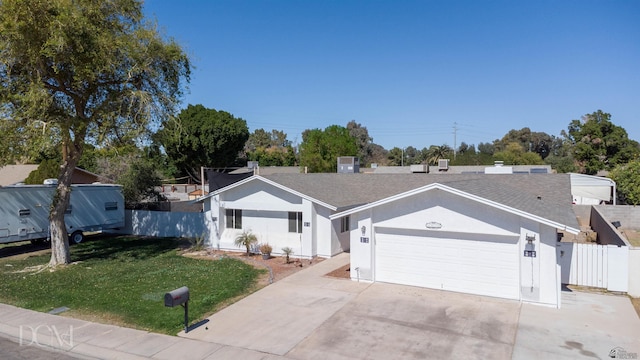 ranch-style house featuring fence, a front lawn, a garage, stucco siding, and driveway