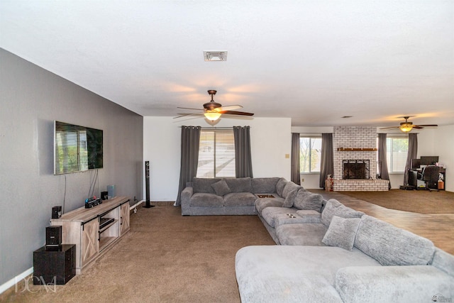 living room featuring baseboards, a ceiling fan, a brick fireplace, and light colored carpet