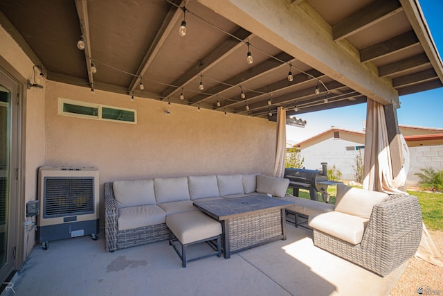 view of patio / terrace with heating unit, fence, and an outdoor living space