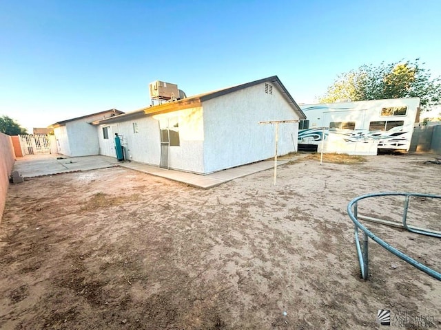 161 Las Praderas St, San Luis, AZ 85336 - rear view of property with central air condition unit, fence, and stucco siding