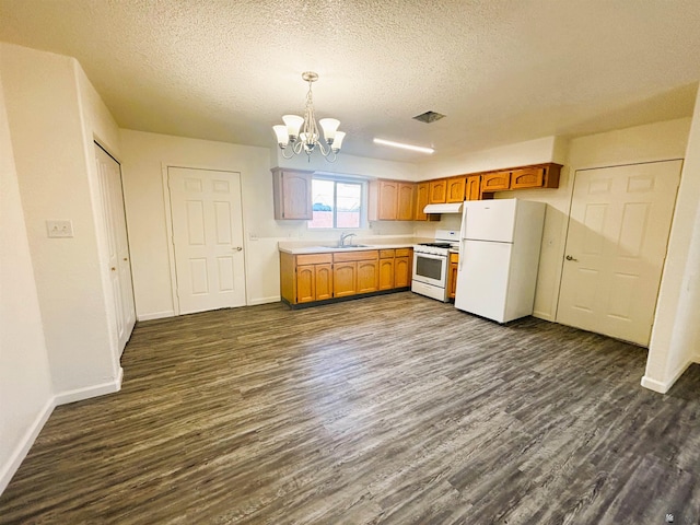 161 Las Praderas St, San Luis, AZ 85336 - kitchen with white appliances, baseboards, a sink, dark wood finished floors, and a notable chandelier