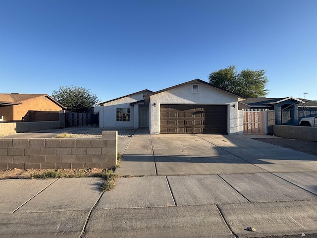 161 Las Praderas St, San Luis, AZ 85336 - ranch-style house featuring fence, stucco siding, a gate, an attached garage, and driveway
