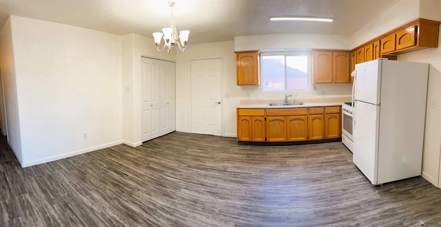 161 Las Praderas St, San Luis, AZ 85336 - kitchen featuring white appliances, an inviting chandelier, a sink, and dark wood-type flooring