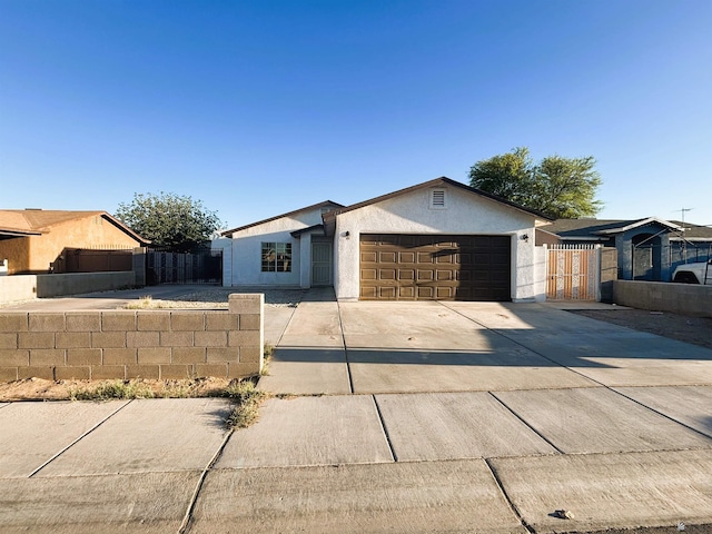 161 Las Praderas St, San Luis, AZ 85336 - view of front of house featuring concrete driveway, an attached garage, fence, and stucco siding