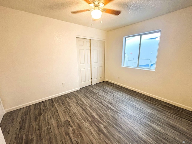 161 Las Praderas St, San Luis, AZ 85336 - unfurnished bedroom featuring ceiling fan, dark wood-style flooring, a textured ceiling, baseboards, and a closet