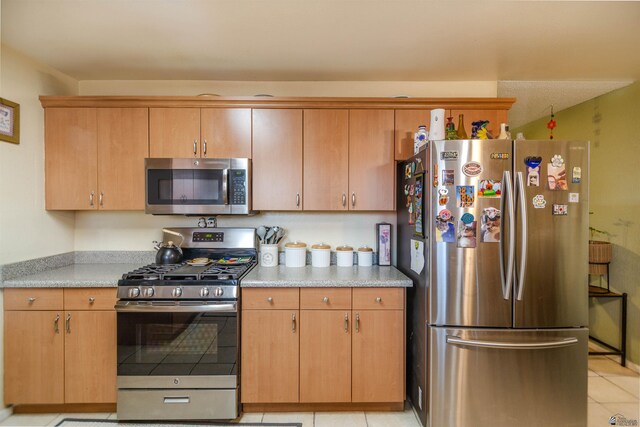 1180 E 26th Pl, Yuma, AZ 85365 - kitchen featuring appliances with stainless steel finishes, light countertops, and light tile patterned floors
