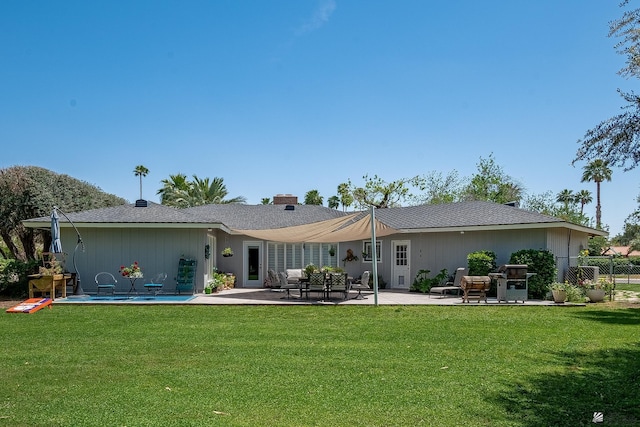 rear view of property with a lawn, fence, a patio, and a chimney