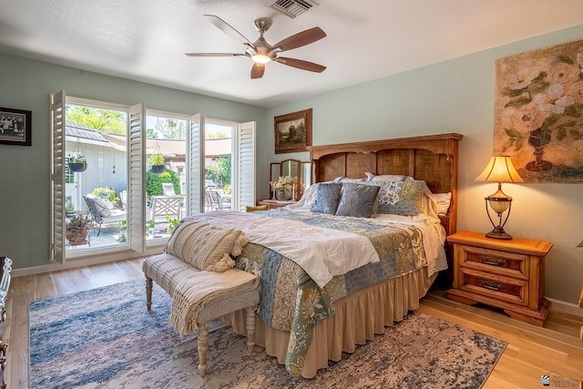 bedroom featuring access to outside, baseboards, visible vents, and light wood-style flooring
