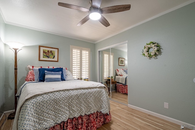 bedroom with crown molding, baseboards, a ceiling fan, and light wood-style flooring