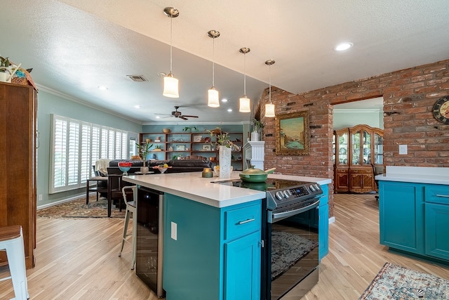 kitchen featuring range with electric cooktop, visible vents, crown molding, light wood-type flooring, and beverage cooler