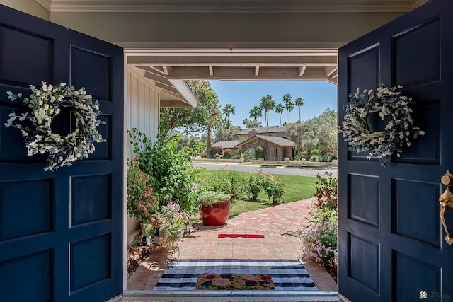 doorway to outside featuring crown molding