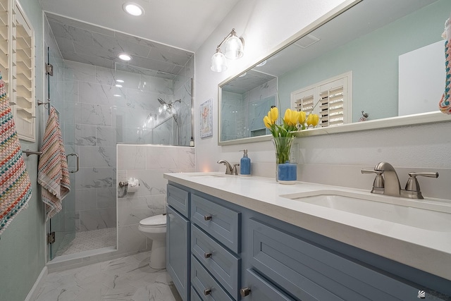 bathroom with a sink, toilet, marble finish floor, recessed lighting, and a shower stall