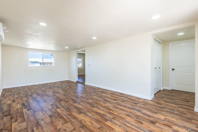 spare room with recessed lighting, dark wood finished floors, and baseboards