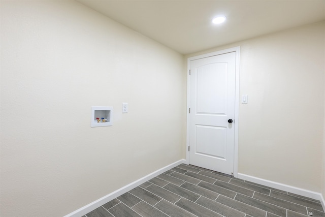 washroom featuring baseboards, laundry area, wood finish floors, and hookup for a washing machine
