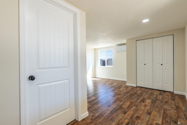 hall featuring an AC wall unit, recessed lighting, dark wood finished floors, and baseboards