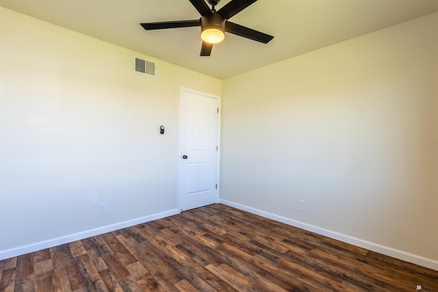 empty room with baseboards, ceiling fan, dark wood-style floors, and visible vents