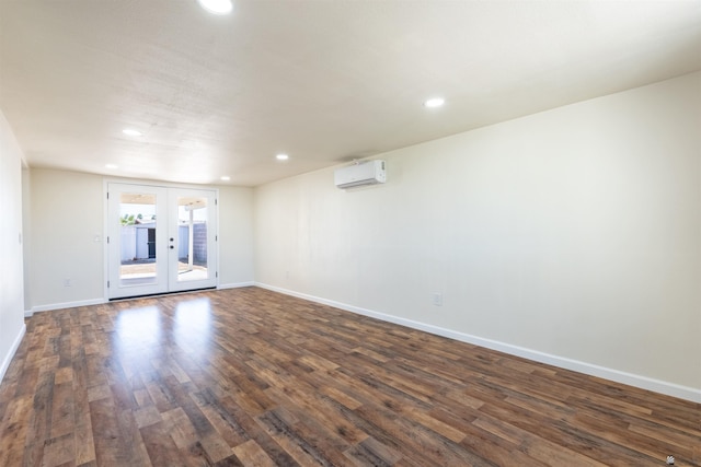 empty room featuring recessed lighting, baseboards, dark wood finished floors, and a wall mounted air conditioner