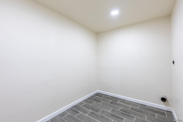 interior space featuring recessed lighting, baseboards, wood finish floors, and laundry area