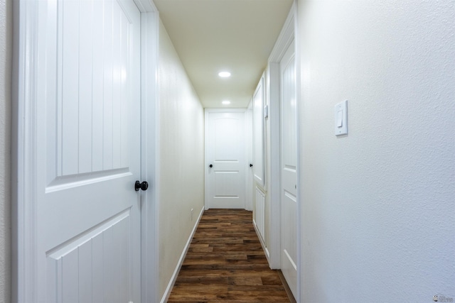 hallway with recessed lighting, dark wood-style flooring, and baseboards