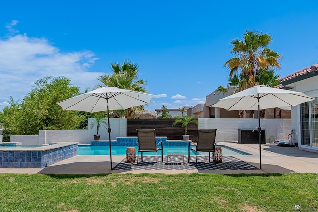 view of swimming pool with an in-ground hot tub, a patio, and a fenced backyard