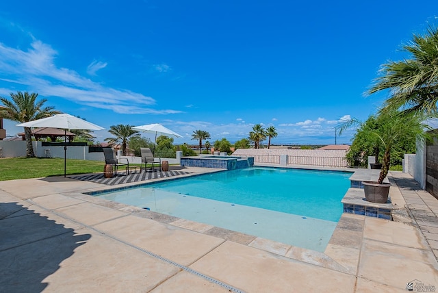 view of pool featuring a fenced backyard, a patio area, and a pool with connected hot tub