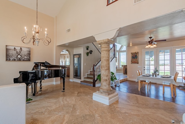 foyer entrance with baseboards, stairway, a ceiling fan, arched walkways, and a chandelier