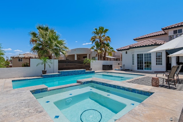 view of pool featuring a fenced backyard, a patio, and a pool with connected hot tub