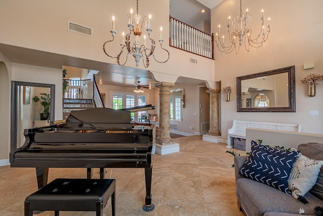sitting room featuring a chandelier, decorative columns, baseboards, a high ceiling, and marble finish flooring