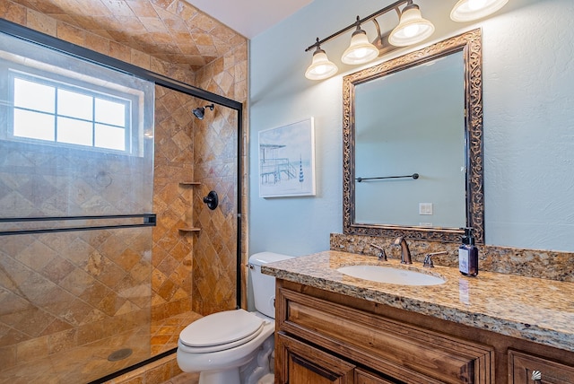 full bath featuring a stall shower, toilet, and vanity