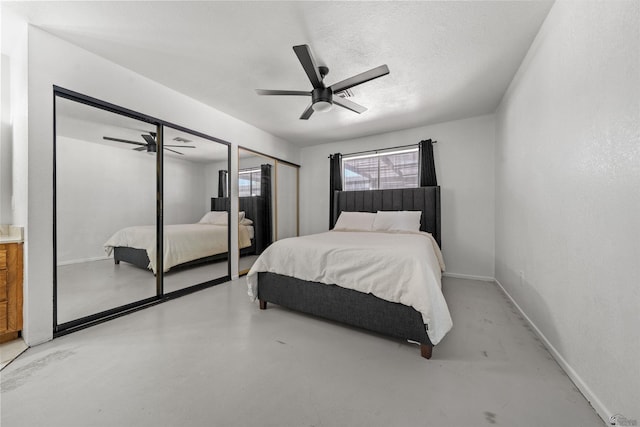 2045 S 14th Ave Unit 74, Yuma, AZ 85364 - bedroom featuring multiple closets, concrete floors, a ceiling fan, and baseboards