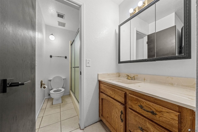 2045 S 14th Ave Unit 74, Yuma, AZ 85364 - bathroom with toilet, a shower with door, tile patterned flooring, and vanity