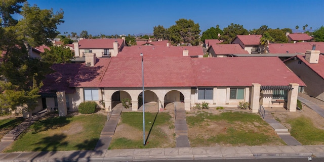 2045 S 14th Ave Unit 74, Yuma, AZ 85364 - view of front of property with stucco siding, a residential view, a front lawn, and a tiled roof