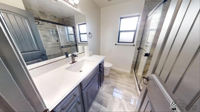 bathroom with vanity, toilet, and an enclosed shower