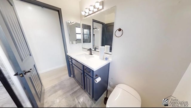 bathroom with vanity and toilet