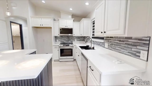 kitchen featuring sink, white cabinets, and stainless steel appliances