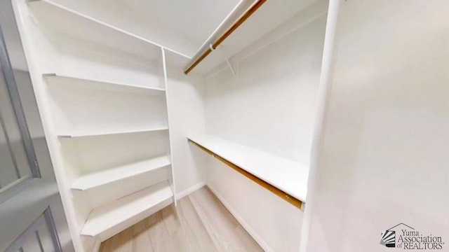 spacious closet featuring hardwood / wood-style flooring